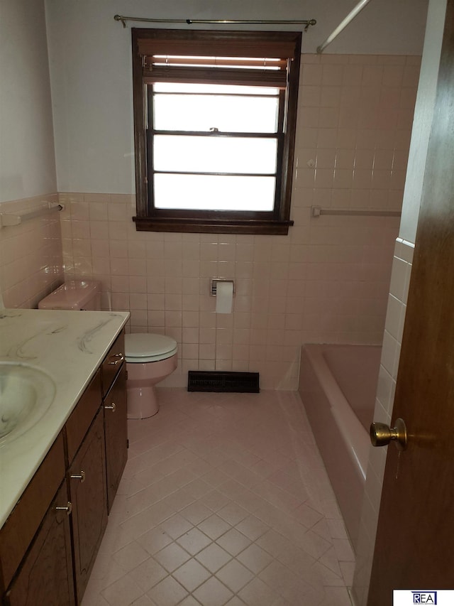 14930 Holmes St, Omaha, NE 68137 - bathroom featuring tile patterned flooring, toilet, vanity, tile walls, and  shower combination