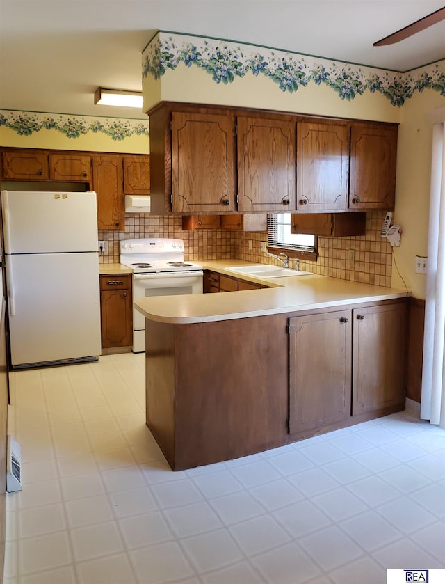 14930 Holmes St, Omaha, NE 68137 - kitchen with white appliances, a sink, a peninsula, light countertops, and tasteful backsplash