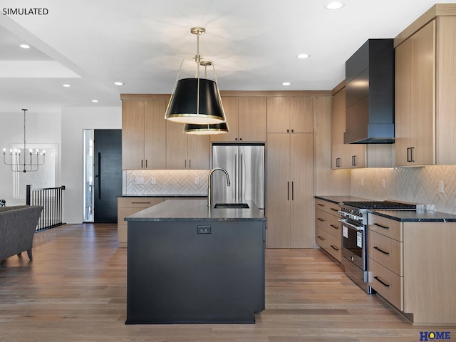 kitchen with high quality appliances, light brown cabinetry, wall chimney exhaust hood, and recessed lighting