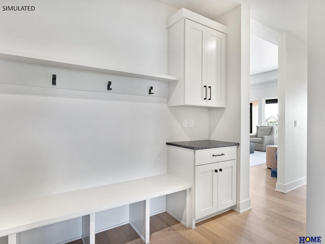 mudroom with light wood-style floors and baseboards
