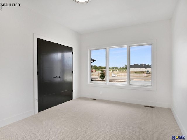 unfurnished bedroom with carpet flooring and baseboards