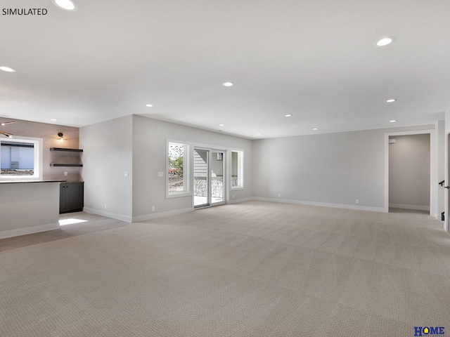 unfurnished living room featuring light colored carpet, recessed lighting, and baseboards