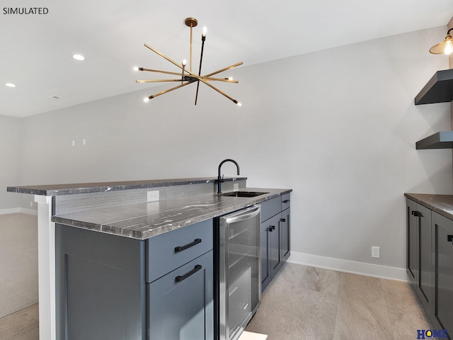 kitchen featuring open shelves, a chandelier, wine cooler, a sink, and baseboards