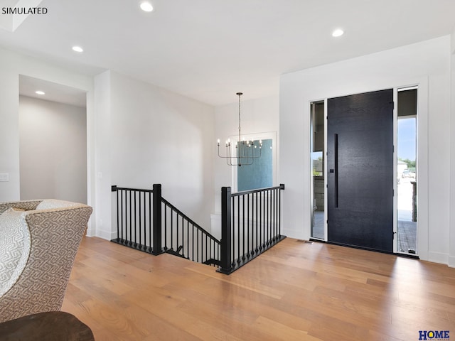 entrance foyer with wood finished floors, a chandelier, recessed lighting, and baseboards