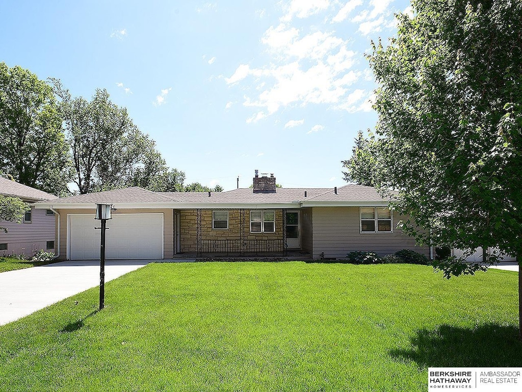 821 Parkwood Ln, Omaha, NE 68132 - single story home with a garage, concrete driveway, a front yard, and a chimney