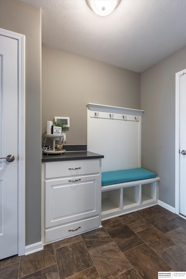 mudroom featuring a textured ceiling