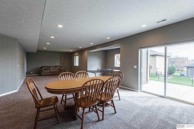 dining room featuring light colored carpet, recessed lighting, and baseboards