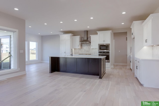 21108 Arlington St, Elkhorn, NE 68022 - kitchen with wall chimney range hood, tasteful backsplash, stainless steel appliances, white cabinetry, and light wood-style floors