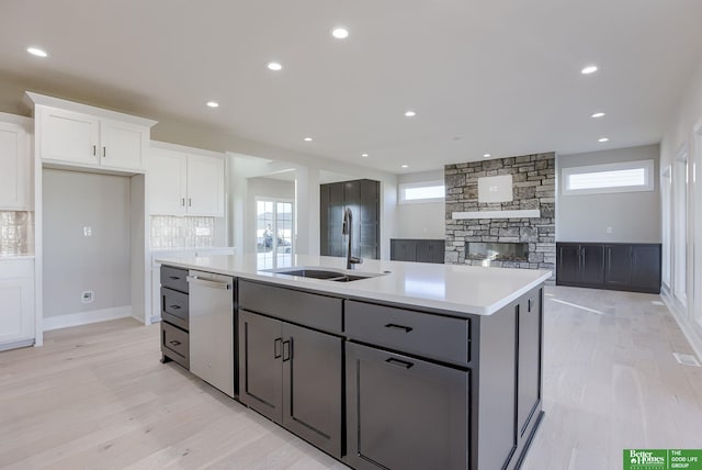 21108 Arlington St, Elkhorn, NE 68022 - kitchen with stainless steel dishwasher, a sink, white cabinetry, light wood-type flooring, and recessed lighting