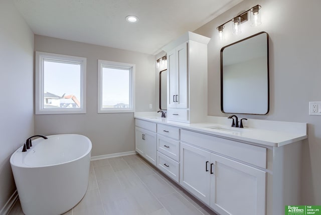 21108 Arlington St, Elkhorn, NE 68022 - bathroom with a freestanding bath, double vanity, baseboards, and recessed lighting