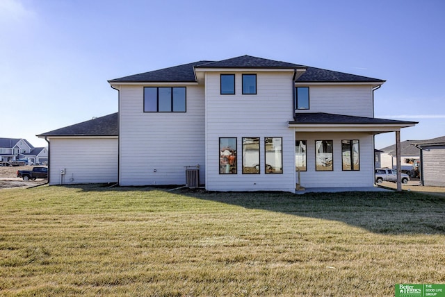 21108 Arlington St, Elkhorn, NE 68022 - back of property with central AC unit, a yard, and a shingled roof
