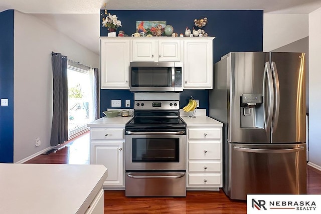 kitchen featuring appliances with stainless steel finishes, light countertops, and white cabinetry