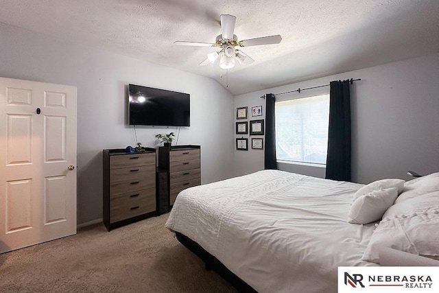 bedroom with light colored carpet, a textured ceiling, ceiling fan, and lofted ceiling