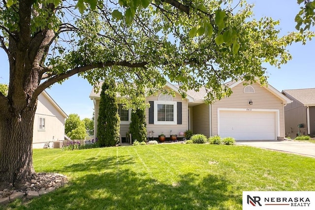 view of front facade featuring an attached garage, concrete driveway, and a front lawn