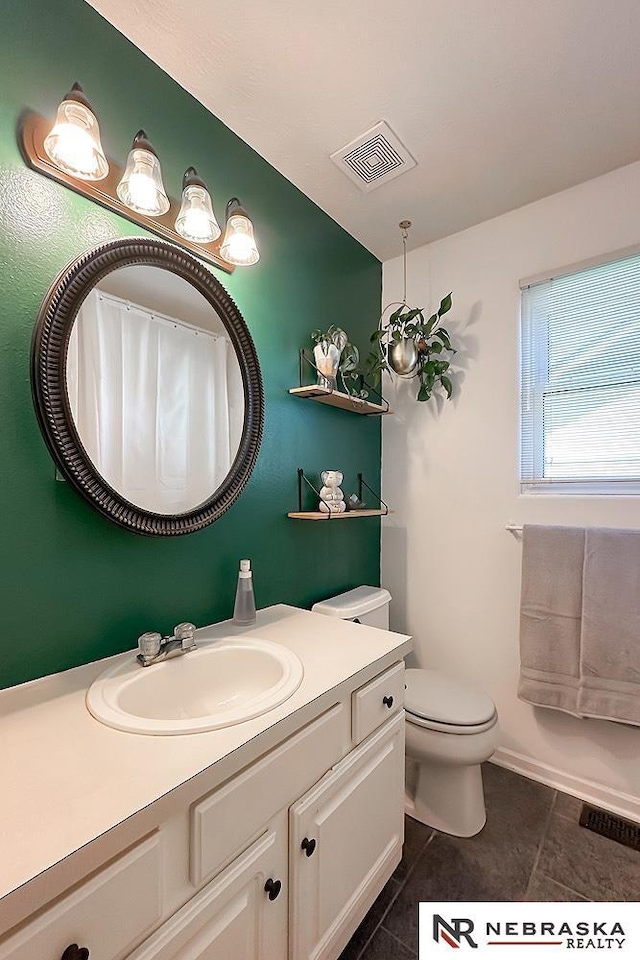 full bath with tile patterned floors, vanity, and toilet