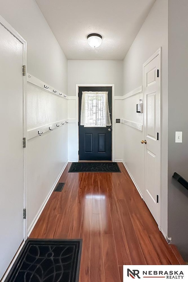 entryway featuring wood finished floors and baseboards