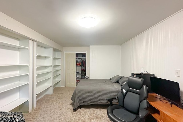 carpeted bedroom featuring a closet and an office area