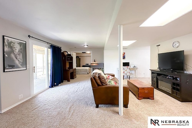 living room featuring light colored carpet and baseboards