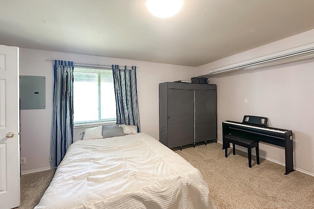 bedroom featuring light colored carpet, baseboards, and electric panel