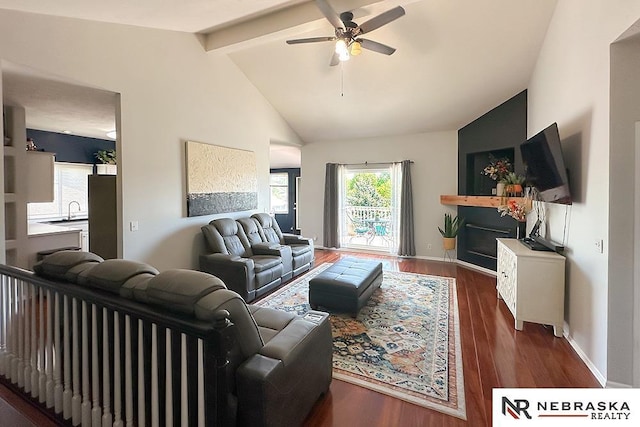 living room featuring ceiling fan, wood finished floors, and baseboards
