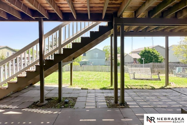 view of patio featuring stairs and a residential view