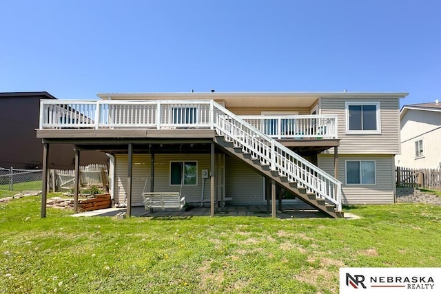 rear view of property with stairs and a deck