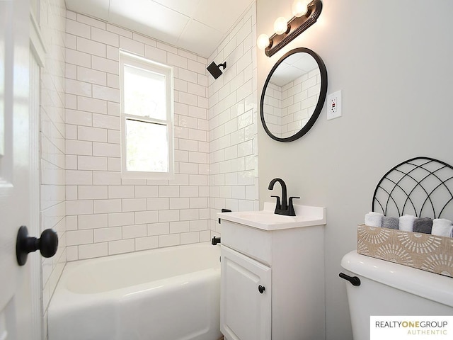 bathroom featuring vanity, tub / shower combination, and toilet