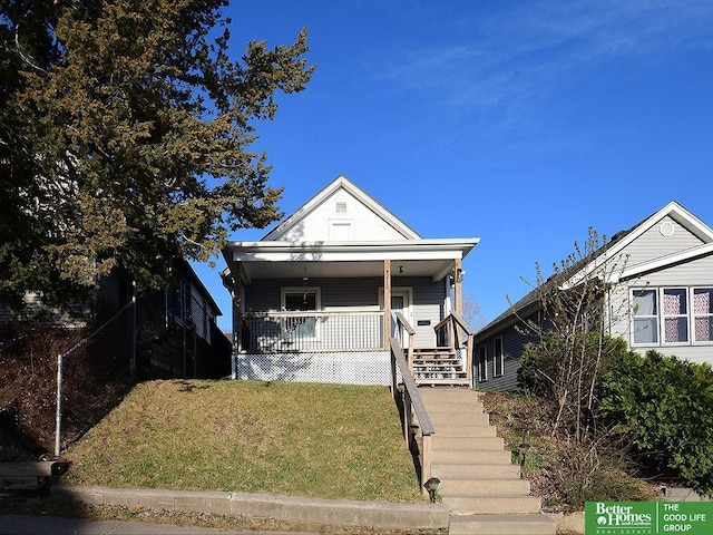 4210 S 21st St, Omaha, NE 68107 - shotgun-style home featuring stairs, a front yard, and a porch