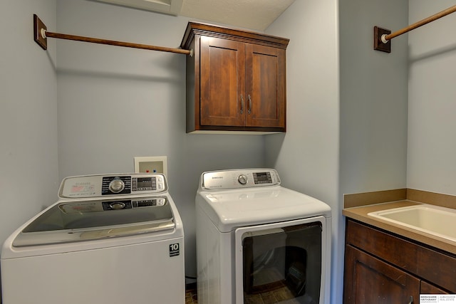 washroom with separate washer and dryer and cabinet space