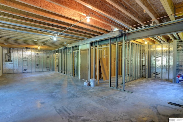 unfinished basement featuring electric panel