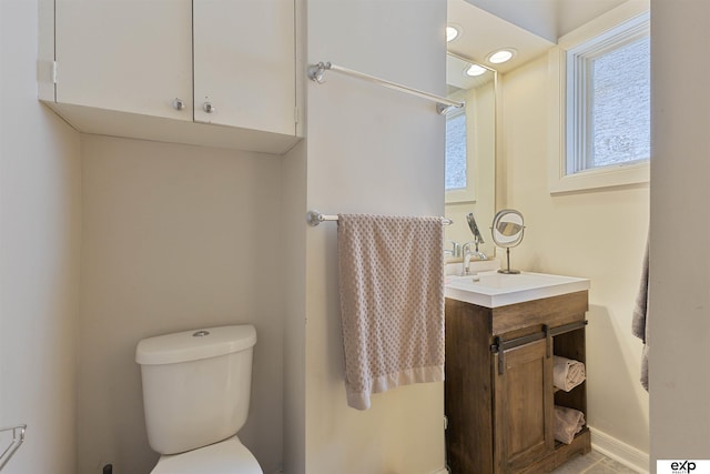 2939 Martha St, Omaha, NE 68105 - bathroom featuring toilet, vanity, and baseboards