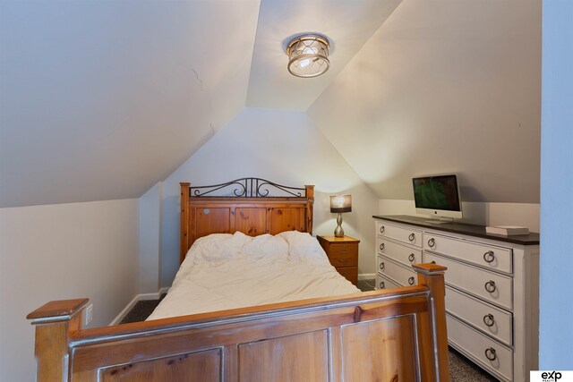 2939 Martha St, Omaha, NE 68105 - bedroom featuring lofted ceiling, baseboards, and dark carpet