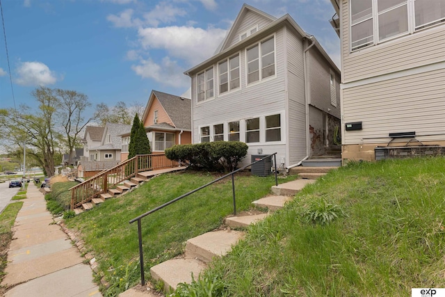 2939 Martha St, Omaha, NE 68105 - back of property featuring a lawn and central AC unit