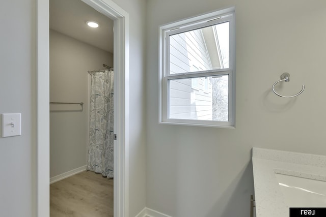 4406 Barksdale Dr, Bellevue, NE 68123 - bathroom featuring healthy amount of natural light, wood finished floors, baseboards, and a shower with curtain