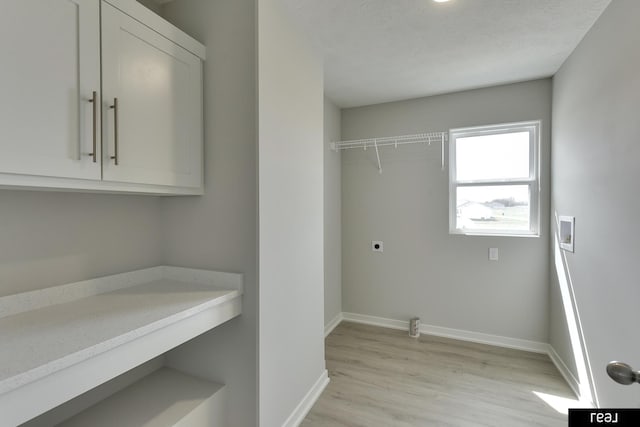 4406 Barksdale Dr, Bellevue, NE 68123 - washroom featuring light wood-style flooring, hookup for a washing machine, baseboards, hookup for an electric dryer, and cabinet space