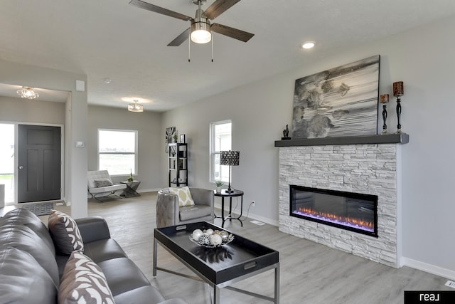 4406 Barksdale Dr, Bellevue, NE 68123 - living room featuring a fireplace, wood finished floors, a ceiling fan, and baseboards