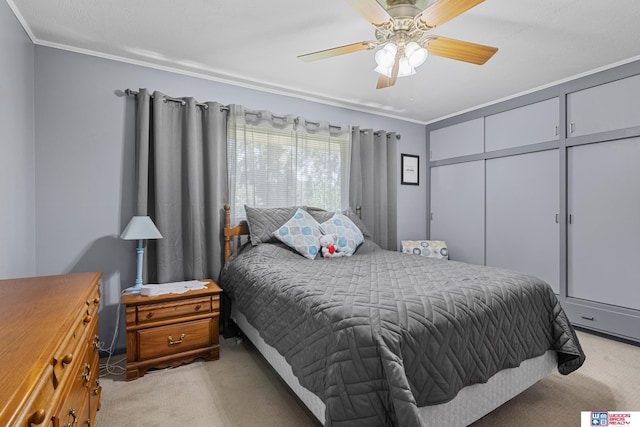 4511 E Eden St, Lincoln, NE 68506 - bedroom with light colored carpet, crown molding, a ceiling fan, and a closet