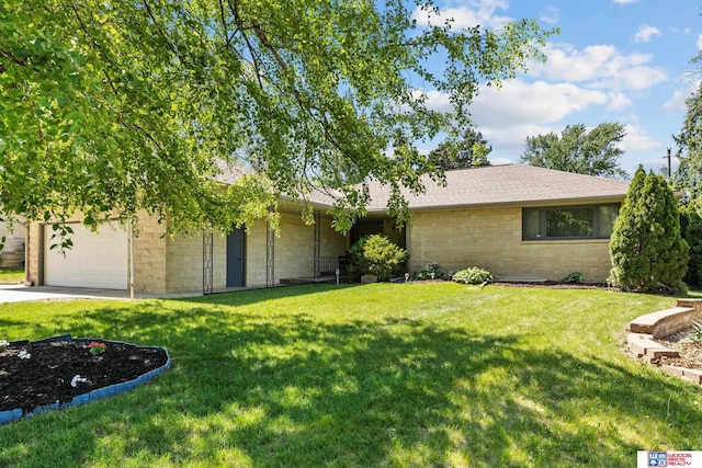 4511 E Eden St, Lincoln, NE 68506 - view of front of property featuring a front yard, driveway, a garage, and stone siding