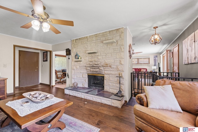 4511 E Eden St, Lincoln, NE 68506 - living area with crown molding, a ceiling fan, wood finished floors, and a stone fireplace