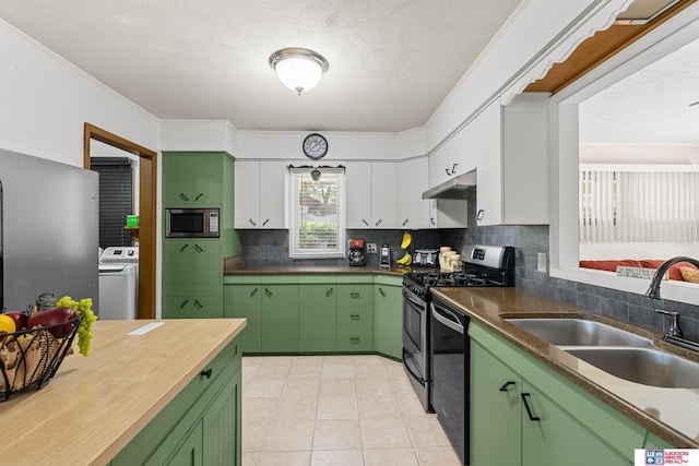 4511 E Eden St, Lincoln, NE 68506 - kitchen with green cabinetry, stainless steel appliances, a sink, washer / dryer, and tasteful backsplash