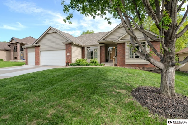 view of front of home with brick siding, a garage, concrete driveway, and a front lawn