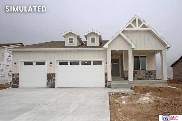 1065 S 9th Ave, Ashland, NE 68003 - view of front of home featuring stone siding, a porch, a garage, driveway, and board and batten siding