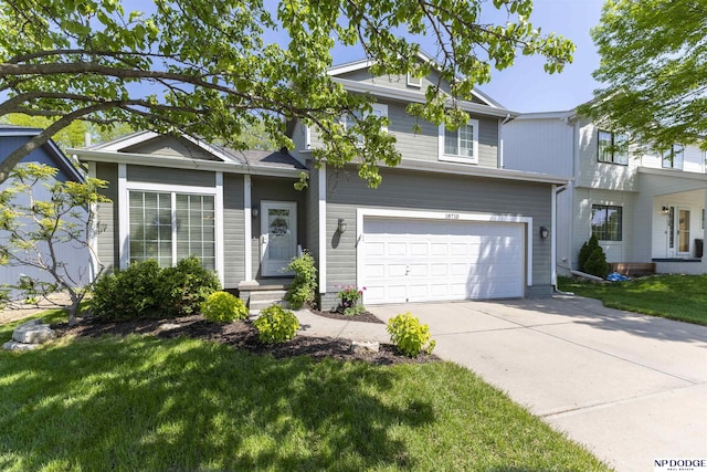 view of front of property featuring a front yard, an attached garage, and concrete driveway