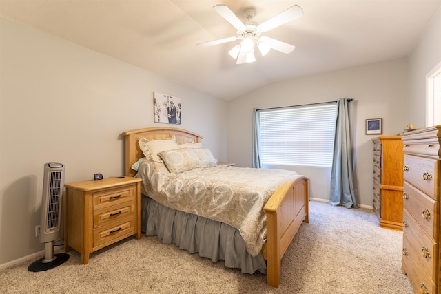 bedroom with light colored carpet, multiple windows, lofted ceiling, baseboards, and a ceiling fan