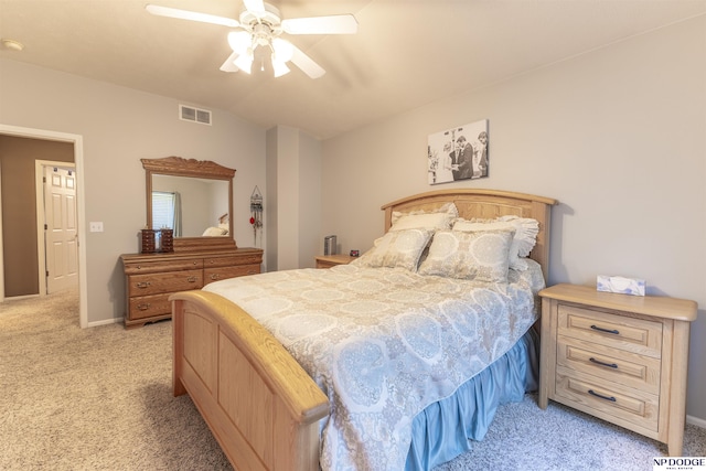bedroom featuring light colored carpet, lofted ceiling, a ceiling fan, and baseboards
