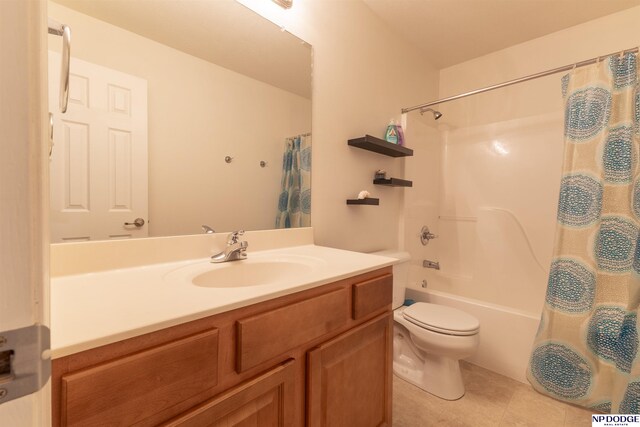bathroom with vanity, toilet, tile patterned floors, and shower / tub combo