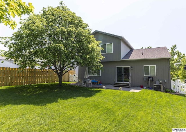 rear view of house with a patio area and a shingled roof