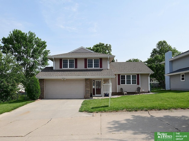 14824 Charles Plz, Omaha, NE 68154 - view of front of property with driveway, a front yard, a garage, brick siding, and a shingled roof