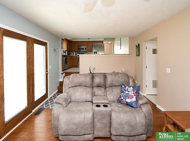 14824 Charles Plz, Omaha, NE 68154 - living area with plenty of natural light, light wood-type flooring, and baseboards
