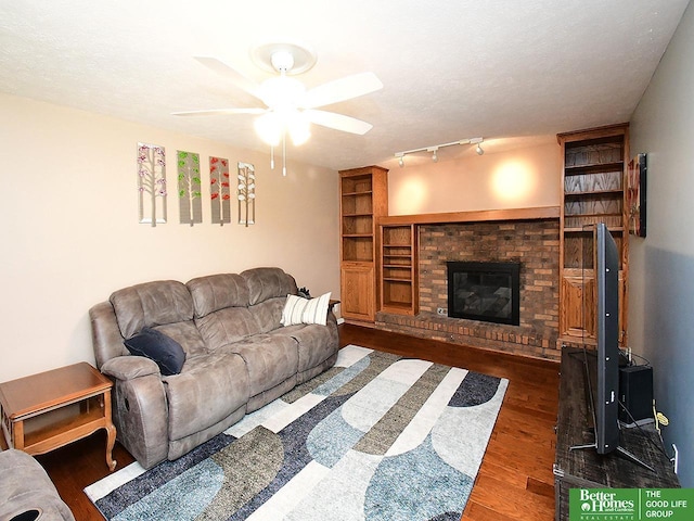 14824 Charles Plz, Omaha, NE 68154 - living room with wood finished floors, ceiling fan, and a brick fireplace